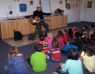 Terrence Farrell teaching  school children about the guitar